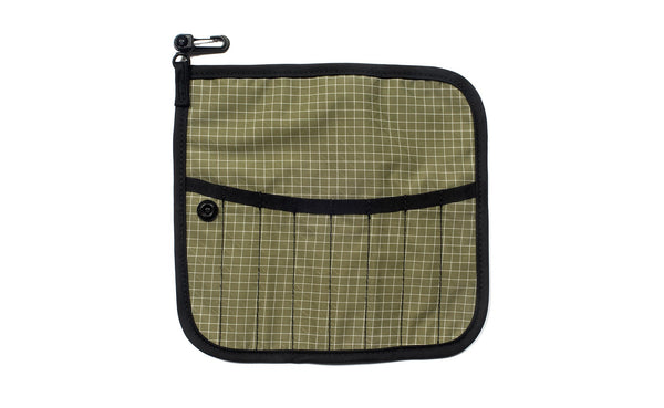 The front of a Tool Pen Wrap in Taiga (olive green with white grid) 200 Halcyon.